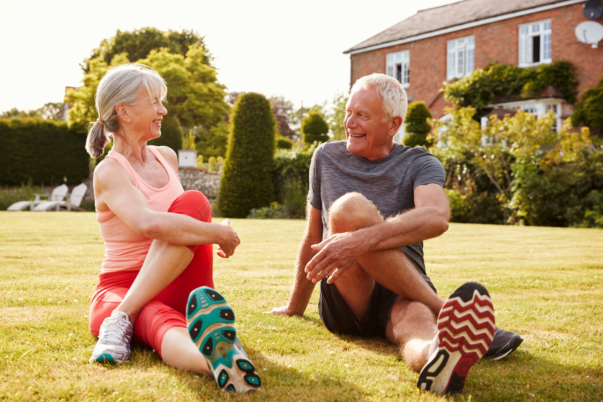 healthy-senior-couple-exercising-in-garden-togethe-2021-08-26-16-13-55-utc